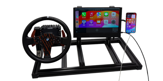 The experimental set-up of the ‘BMW Virtual Cockpit’ consists of a device constructed by the students that connects a steering wheel, pedals, a touchscreen and a smartphone holder. (Source: adesso)