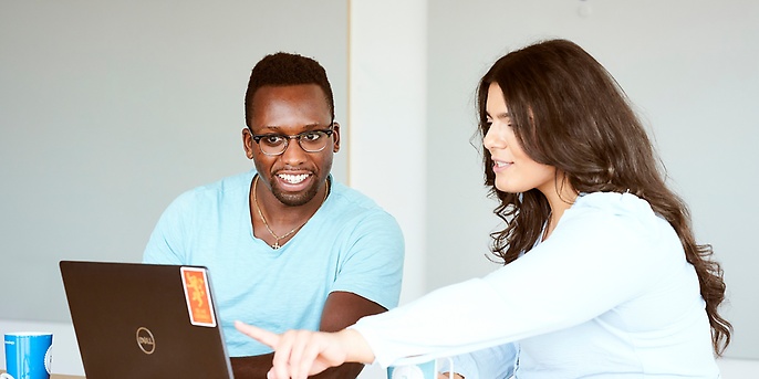 employees looking at a notebook