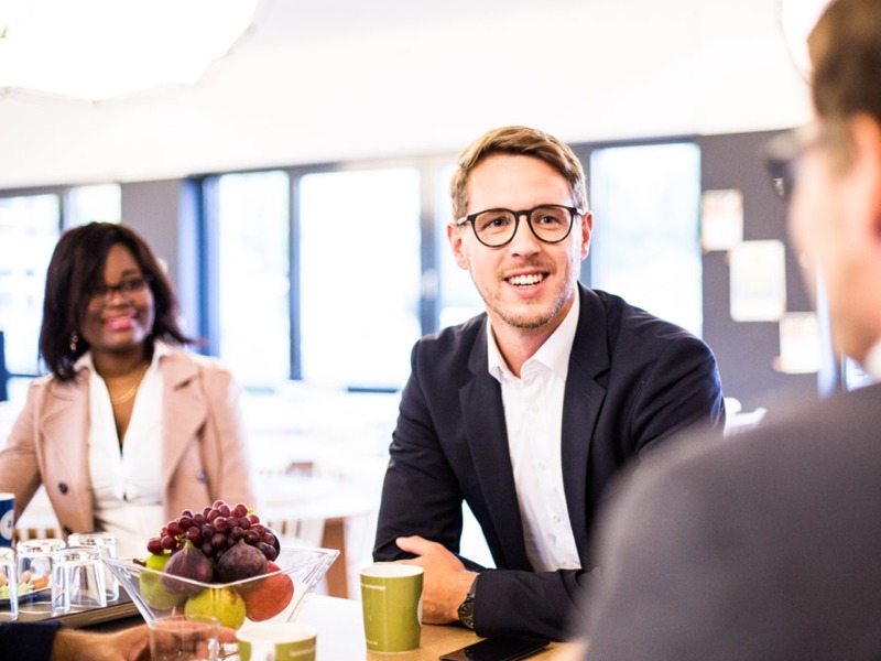 adesso employees in a conference