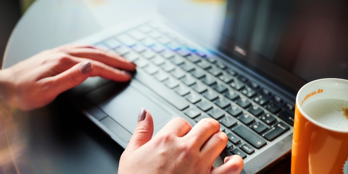 hands on laptop keyboard